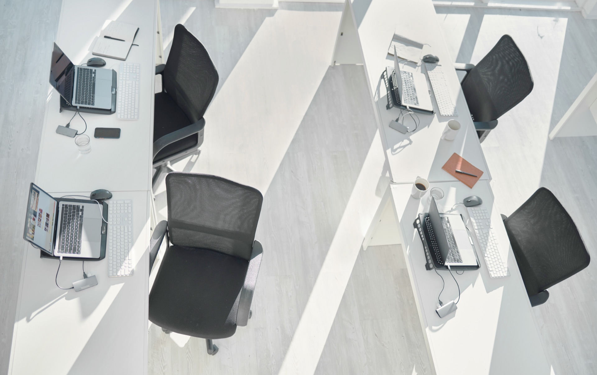 Top view, empty office interior and table with laptops in coworking space in creative startup compa